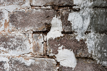 Texture of a brick wall with cracks and scratches which can be used as a background