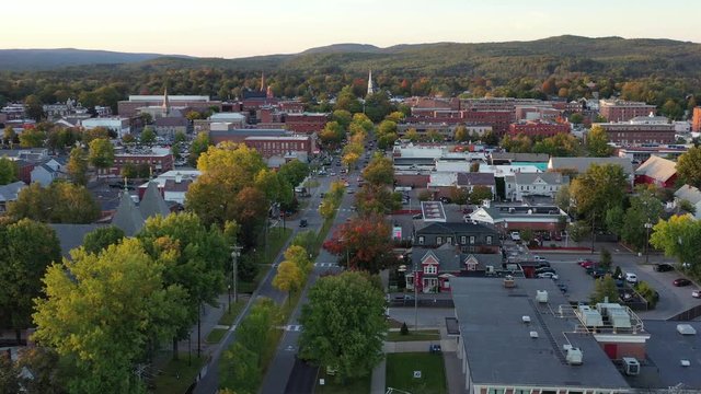 Aerial drone video flying forward above Main St in downtown Keene, New Hampshire at sunset 