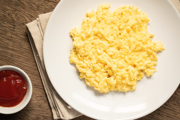 Scramble on a white plate with copy space,ketchup bowl