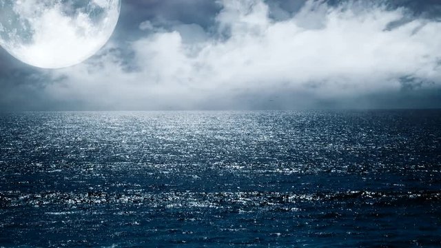 Looped night view of sea waves and blue sky with clouds and moon
