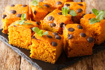 Autumn pumpkin bars with chocolate drops and mint close-up on a slate board. horizontal