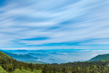 Mountains and sea of clouds under blue sky and white clouds, mount emei, sichuan province, China
