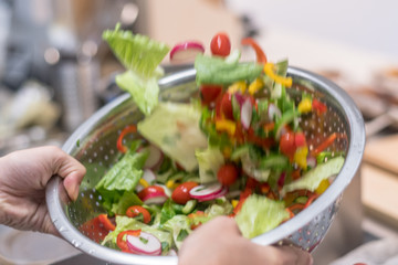 Isolated close up of an organic vegetable salad in the making