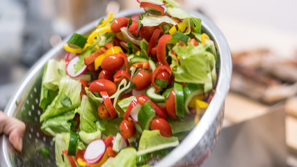 Isolated close up of an organic vegetable salad in the making