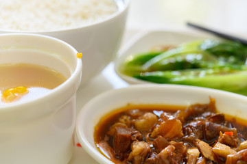 side view braised veal cheeks with cabbage and maize soup and rice