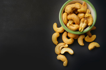 cashew nuts in a bowl black background