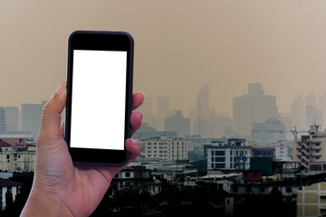 hand holding smart phone with blank screen of  building background
