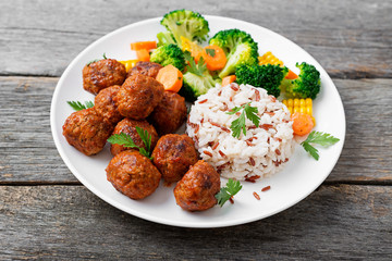 Homemade meatballs with fried rice and broccoli salad, portion for lunch or dinner. 