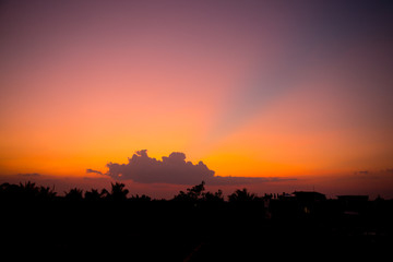 Fiery sunset landscape with darkness foreground in siem reap city in Cambodia during rainy season 