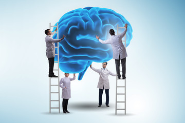 Team of doctors examining human brain