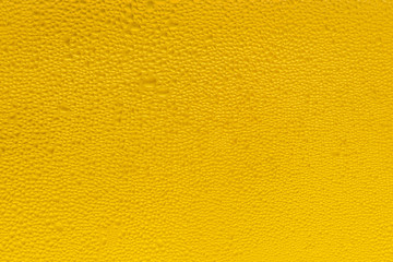 Naklejka premium Background of water drops on the surface in golden colors