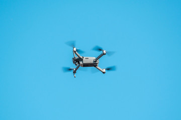 Drone quadcopter on blue sky background