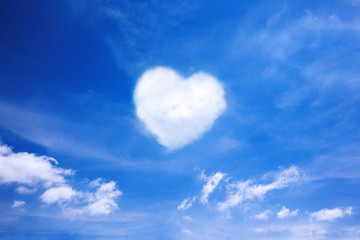 Naklejka na ściany i meble White cloud in the shape of a heart in the blue sky. Natural shape heart in the sky with clouds. Heart shaped cloud over blue sky.