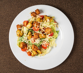 caesar salad on the white plate