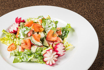 salad with fresh vegetables on the white plate
