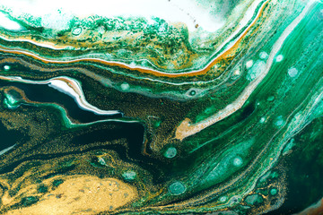 Green and gold ripples abstract background.