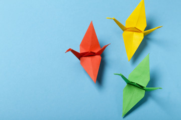 origami paper crane on a blue background