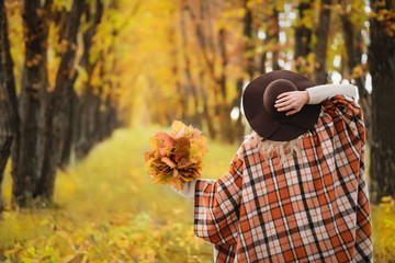 Beautiful Autumn Woman with Autumn Leaves on Fall Nature.