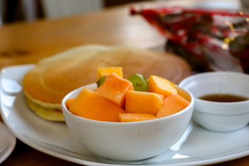 Naklejka na ściany i meble Sliced papaya and grapes with pan cake served as breakfast
