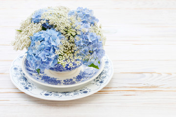 Floral arrangement with blue hortensia (hydrangea) and white Queen Anne's lace