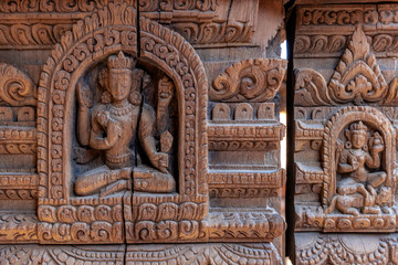 Detailed wood carvings of Hindu Gods and sculptures on ancient temples of Nepal.