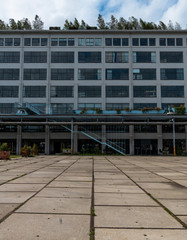 Leading lines on the ground leading to a blue staircase