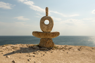 Fototapeta na wymiar a statue of a thinker on the cape of the Tarkhankut in the Crimea