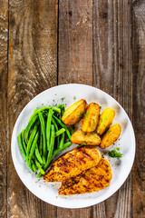 Grilled chicken fillets, baked potatoes and green beans