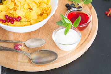 good breakfast Healthy tasty breakfast cornflakes with strawberries, raspberries, black currants and red currants.