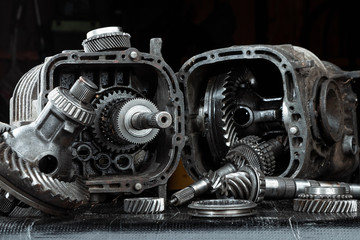 Dismantled car gearbox with gears, close-up. Repair box predach, repair of used cars. Metal background.
