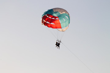 paragliding in the sky over the blue sea