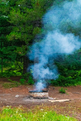 Fototapeta na wymiar Campfire Smoking In Camp Site
