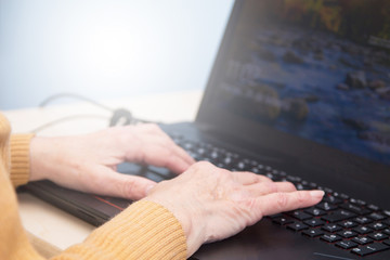 senior woman hands using laptop