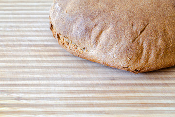 Whole grain round bread. Brightly lit from the side