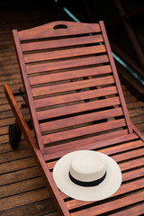 Fototapeta na wymiar Straw hat on the deck chair