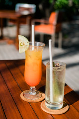 glass of orange juice on wooden table
