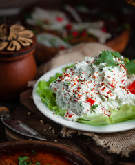 Vegetable salad in mayonnaise topped with pepper