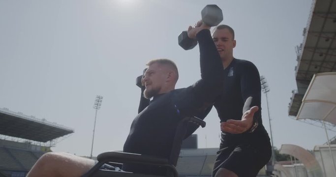 Wheelchaired athlete lifting kettlebell