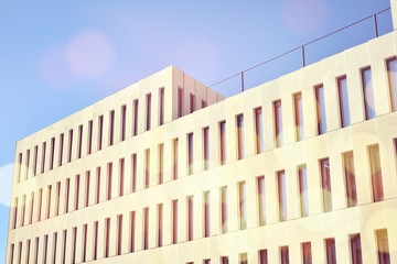 Modern office building detail. Perspective view of geometric angular concrete windows on the facade...