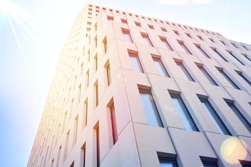 Modern office building detail. Perspective view of geometric angular concrete windows on the facade...
