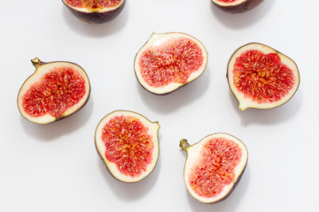halves of fresh figs on a white background top view