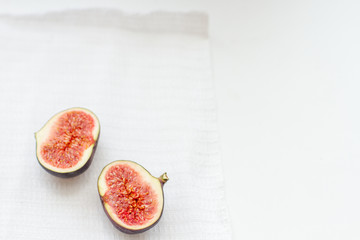 halves of fresh figs on a white background