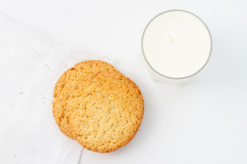 oatmeal cookies and a glass of milk on a white background. top view