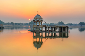 Gadisar lake in the morning at sunrise. Man-made water reservoir with temples in Jaisalmer. India