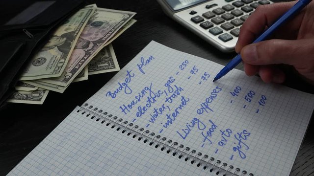 A man plans monthly bills and expenses. Household budget and financial planning