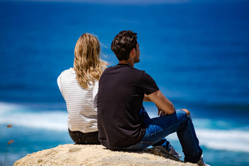 Couple looking at a tropical ocean / sea scenery.