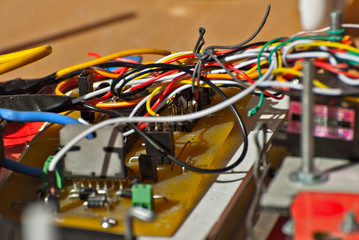 Electronics and robotics of handmade. Microcircuits and colored wires close up. Electronic devices and mechanisms are presented at the scientific exhibition.