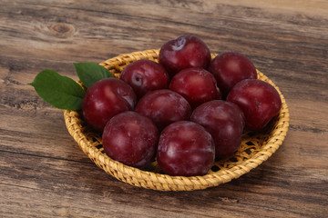 Plum heap in the wooden basket