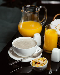 Creamy mushroom soup served with orange juice