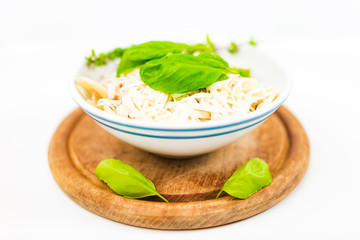 Italian pasta with tomato sauce, parmesan cheese, fresh oregano - on white background.